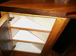 Triangular shelves in bar end cabinet