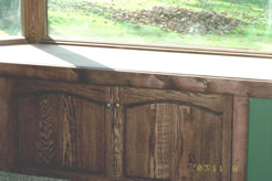 Cabinets under window seat, opposite wall