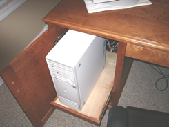 Door conceals roll-out tray for computer