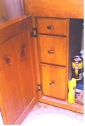 Storage drawers behind door