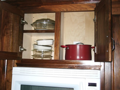 Partitioned cabinet with shelf on one side